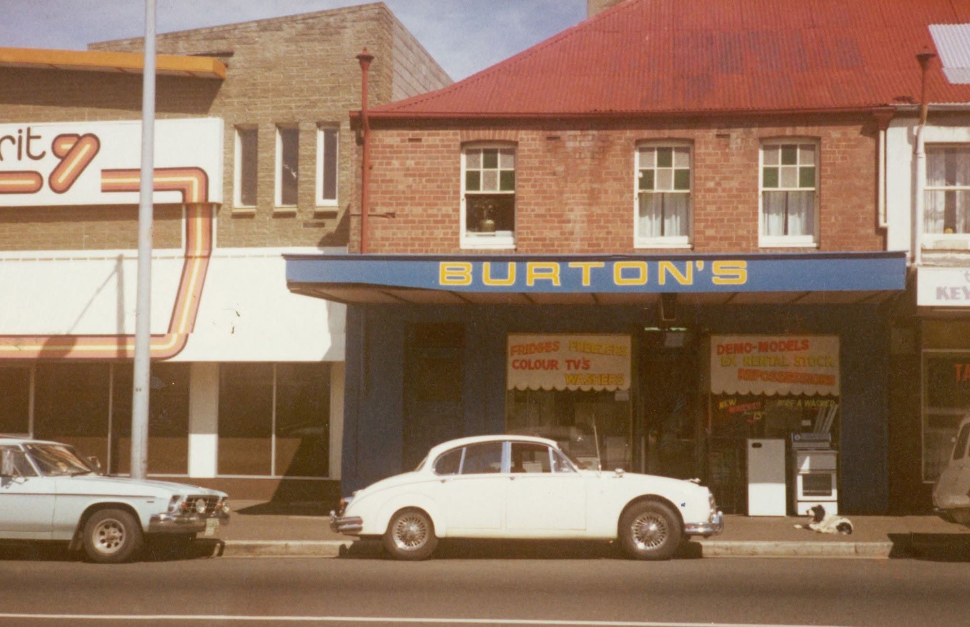 Burton's shopfront in North Hobart in the 1970s, with a white Jaguar parked out front